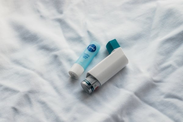 Woman using asthma inhaler